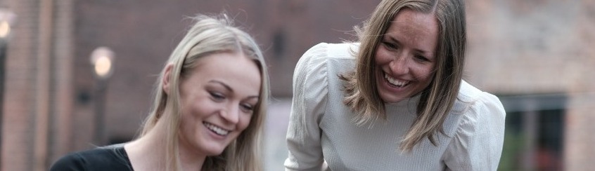 Background image of two women smiling