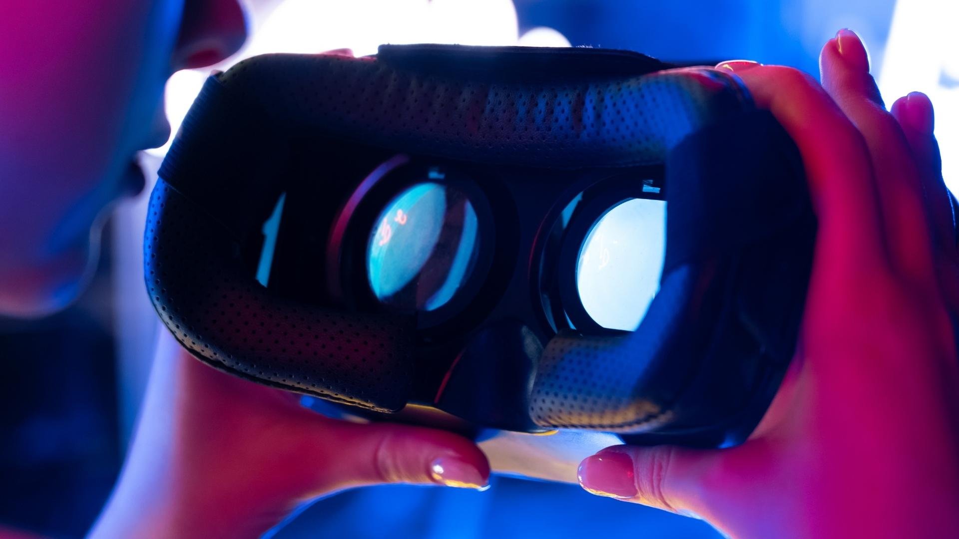 someone holding a pair of VR glasses